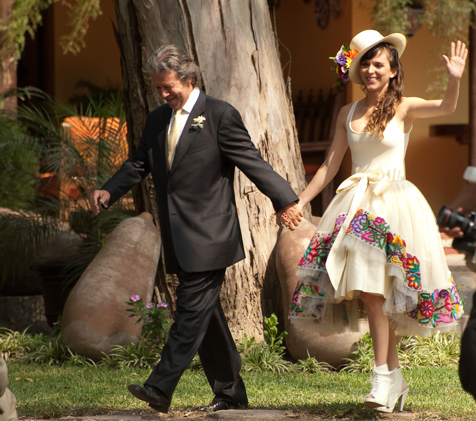 Bride waving away at her wedding day 